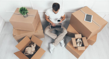 Top view. Man moving into his new home
